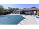 Backyard pool with covered surface, outside dining, and view of house at 4421 Greenmeadow Ct, Indianapolis, IN 46235