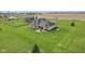 Aerial angle of a home's back patio with manicured landscaping and spacious lawn at 4634 E 1000 N, Pittsboro, IN 46167