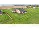Aerial view of backyard patio and landscaping surrounded by a lush lawn at 4634 E 1000 N, Pittsboro, IN 46167