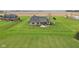 Aerial view of a rear patio and manicured lawn in a serene, rural setting at 4634 E 1000 N, Pittsboro, IN 46167
