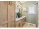 Bathroom with a double vanity, wood accents, and ample storage in the custom cabinetry at 4634 E 1000 N, Pittsboro, IN 46167