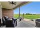 Covered patio with comfortable seating and a picturesque view of the expansive green lawn at 4634 E 1000 N, Pittsboro, IN 46167