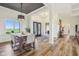 Open concept dining area features hardwood floors, modern lighting, and a view of the outdoors at 4634 E 1000 N, Pittsboro, IN 46167