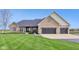 Charming brick home featuring an attached garage, covered porch, and well-manicured lawn at 4634 E 1000 N, Pittsboro, IN 46167