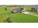 Beautiful brick home featuring an attached two-car garage and large manicured front lawn at 4634 E 1000 N, Pittsboro, IN 46167