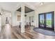 Spacious foyer featuring hardwood floors, modern lighting, and an open layout to the dining area at 4634 E 1000 N, Pittsboro, IN 46167