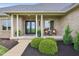 Inviting front porch with elegant pillars, seating, and a charming entrance to the home at 4634 E 1000 N, Pittsboro, IN 46167