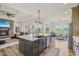 Open kitchen flows to the living and sunroom; features quartz counters, stainless appliances and custom cabinets at 4634 E 1000 N, Pittsboro, IN 46167