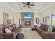 Cozy living room with a stone fireplace, coffered ceiling, and comfortable leather seating at 4634 E 1000 N, Pittsboro, IN 46167