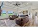 Spacious living room with coffered ceilings, hardwood floors, and open access to the kitchen and backyard views at 4634 E 1000 N, Pittsboro, IN 46167