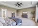 An airy primary bedroom features a tray ceiling and neutral paint, enhancing its serene atmosphere at 4634 E 1000 N, Pittsboro, IN 46167