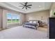 Spacious primary bedroom with a tray ceiling, large window, and plush carpeting at 4634 E 1000 N, Pittsboro, IN 46167