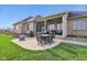 A covered patio features a dining table, grill, and outdoor seating for relaxation and entertainment at 4634 E 1000 N, Pittsboro, IN 46167