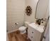 Cozy half bathroom features stylish wallpaper, modern mirror, and a contemporary sink with elegant fixtures at 4810 Oak Hl Dr, Lebanon, IN 46052