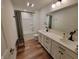 Modern bathroom featuring a double vanity with white countertops and wood-look flooring at 4810 Oak Hl Dr, Lebanon, IN 46052