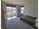 Sunlit bedroom with a neutral palette, features a cozy recliner and large windows at 4810 Oak Hl Dr, Lebanon, IN 46052