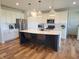 Open kitchen showcasing quartz counters, pendant lights, stainless appliances and center island with seating at 4810 Oak Hl Dr, Lebanon, IN 46052
