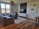 Bright and airy living room with hardwood floors, modern decor, and a large window with scenic views at 4810 Oak Hl Dr, Lebanon, IN 46052