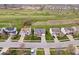Aerial shot of homes, highlighting their neighborhood setting with a golf course and well-manicured lawns at 4922 Birmingham Dr, Indianapolis, IN 46235