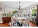 Elegant dining room featuring hardwood floors, ample natural light, and stylish decor at 4922 Birmingham Dr, Indianapolis, IN 46235