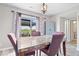 Dining room with a marble table, slider doors to the outside patio, and elegant lighting at 4922 Birmingham Dr, Indianapolis, IN 46235