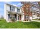 Charming home featuring a blend of brick and siding, complemented by a lush front lawn at 4922 Birmingham Dr, Indianapolis, IN 46235