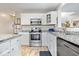 Modern kitchen featuring stainless steel appliances, granite countertops, and white cabinetry at 4922 Birmingham Dr, Indianapolis, IN 46235