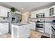 Modern kitchen featuring white cabinetry, stainless steel appliances, and a granite-topped island at 4922 Birmingham Dr, Indianapolis, IN 46235