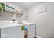 Functional laundry room with shelving, washer, and dryer, providing convenience and organization at 4922 Birmingham Dr, Indianapolis, IN 46235