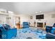 Bright living room featuring a fireplace, hardwood floors, and comfortable blue furniture at 4922 Birmingham Dr, Indianapolis, IN 46235