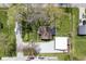 Aerial view of a property featuring lush greenery, a garage, and a convenient driveway for multiple vehicles at 502 N Maple St, Ingalls, IN 46048