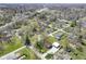 Aerial view of a peaceful neighborhood featuring well-maintained homes and tree-lined streets at 502 N Maple St, Ingalls, IN 46048