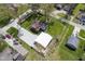 Aerial view captures a charming home with a garage, gravel driveway, and well-maintained lawn at 502 N Maple St, Ingalls, IN 46048