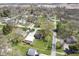 Aerial view of a residential neighborhood showcasing a home with a garage, and a well-kept lawn at 502 N Maple St, Ingalls, IN 46048