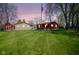 Expansive backyard with lush green grass and detached garage with American flag at 502 N Maple St, Ingalls, IN 46048