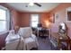This comfortable bedroom is carpeted and features a fan and natural light at 502 N Maple St, Ingalls, IN 46048