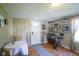 View of the entry room with wood paneling, front door, exercise equipment, and decorative shelving at 502 N Maple St, Ingalls, IN 46048