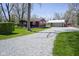 The exterior of this home shows the house, detached garage, and long gravel driveway at 502 N Maple St, Ingalls, IN 46048