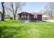 Inviting single-Gathering home features a well-manicured lawn, front porch, and detached garage at 502 N Maple St, Ingalls, IN 46048