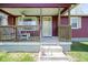 Charming front porch with decorative railings, ceiling fan and steps leading to the front door at 502 N Maple St, Ingalls, IN 46048