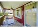 Charming front porch with comfortable seating, fan, and welcoming decor at 502 N Maple St, Ingalls, IN 46048