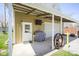 Detached garage with a roll up door, side door and covered carport area at 502 N Maple St, Ingalls, IN 46048