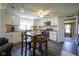 Well-lit kitchen featuring white cabinetry, stainless steel appliances, and dining area at 502 N Maple St, Ingalls, IN 46048