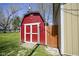This backyard features a red shed for extra storage at 502 N Maple St, Ingalls, IN 46048