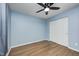 Cozy bedroom with wood floors, ceiling fan, and sliding door closet, perfect for relaxing at 5126 Shadow Pointe Dr, Indianapolis, IN 46254