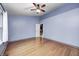Bedroom features hardwood floors, a ceiling fan, and a bright window for plenty of natural light at 5126 Shadow Pointe Dr, Indianapolis, IN 46254