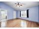 Spacious bedroom with vaulted ceiling, hardwood flooring, and a view to an adjoining bathroom at 5126 Shadow Pointe Dr, Indianapolis, IN 46254