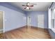Bedroom featuring hard wood floors, a ceiling fan and a door to the bathroom at 5126 Shadow Pointe Dr, Indianapolis, IN 46254