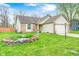 Charming home with well-maintained lawn, brick accents, and vibrant flower garden at 5126 Shadow Pointe Dr, Indianapolis, IN 46254