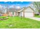 Charming single-Gathering home featuring a well-manicured lawn and beautiful flower beds, creating an inviting curb appeal at 5126 Shadow Pointe Dr, Indianapolis, IN 46254